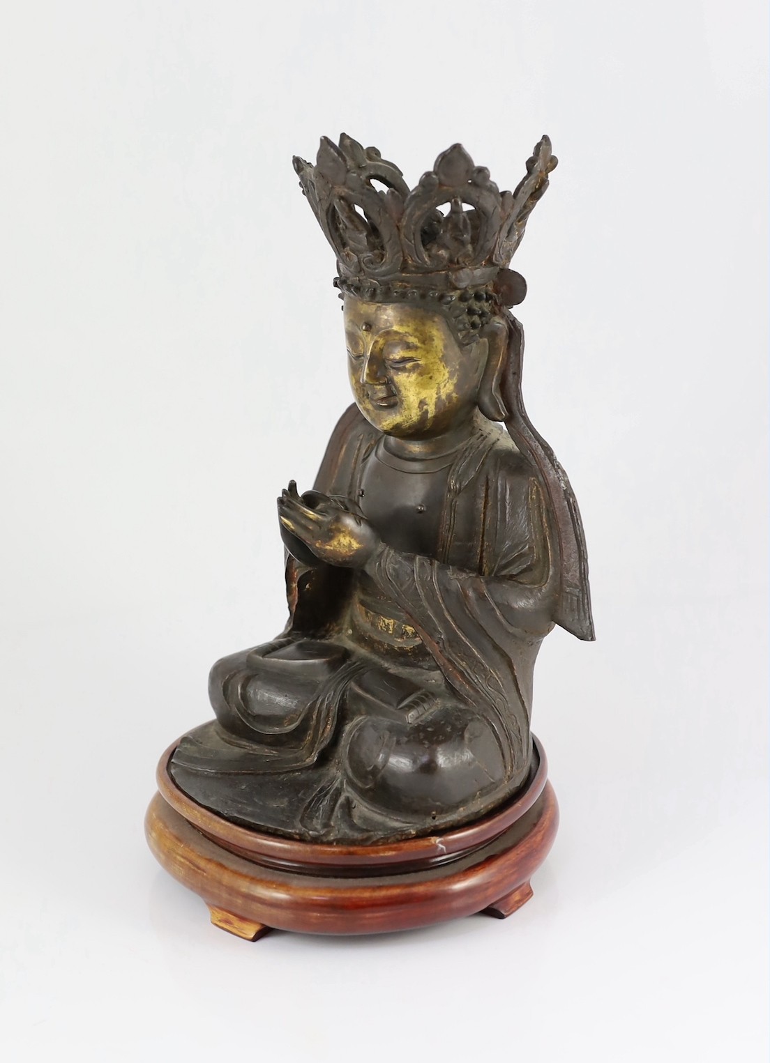 A Chinese late Ming bronze seated figure of Guanyin, 29.5cm high